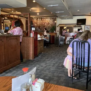 a woman sitting at a table in a restaurant