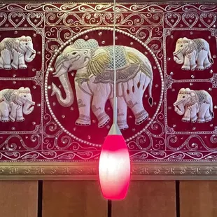 Art and lighting above booth table