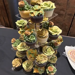 a tower of cupcakes on a table