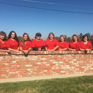 The office staff wearing their red shirts on Friday in support of our trips!