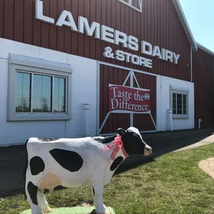 a cow statue in front of a building