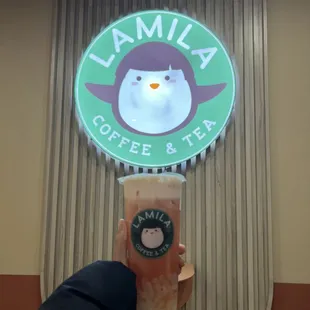 a person holding a cup of coffee