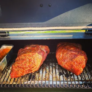 two meats cooking on a grill