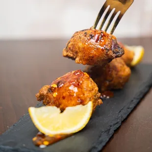 a fork picking up a piece of fried chicken