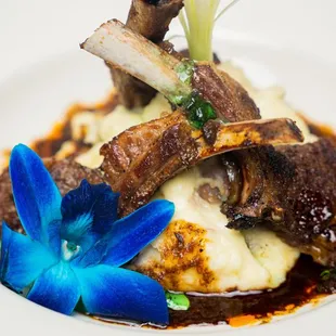 a plate of food with a blue flower