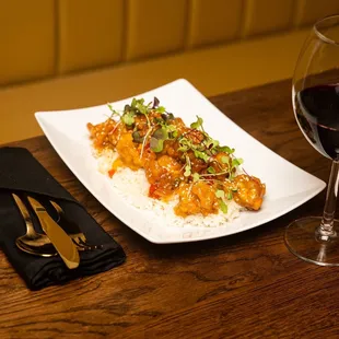 a plate of food and a glass of wine