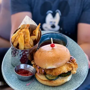 Chicken Sandwich w/ fries and spicy chili sauce on the side (in the back)