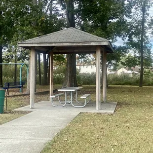 A view of the one pavilion and its picnic table as you approach from the street