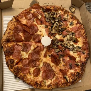 Pepperoni extra cheese with added mushroom on half.