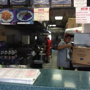 a man standing behind a counter in a restaurant