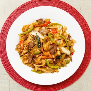 a plate of stir fried beef and vegetables