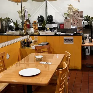 a dining area with tables and umbrellas