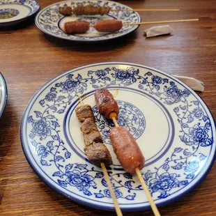 Soup dumplings,  beef skewer, chinese sausage skewer