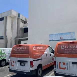 two vans parked in a parking lot