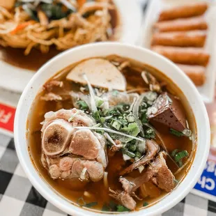 a bowl of soup and a plate of hot dogs