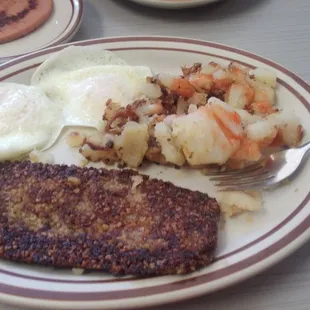 A delicious plate of Hot Goetta, potatoes, and fried eggs.