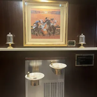 two sinks and a painting