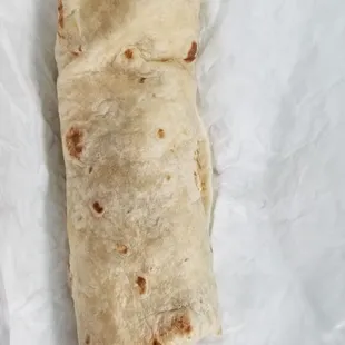 a burrito wrapped in wax paper