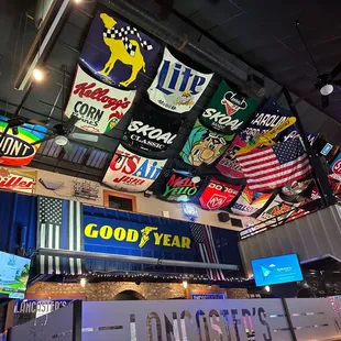 a variety of signs hanging from the ceiling