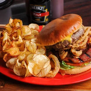 a burger and chips on a red plate