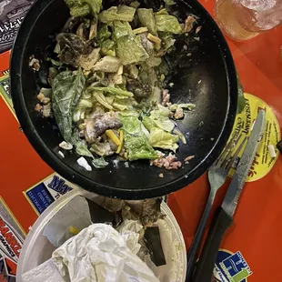 The leftover lettuce that was left in the bowl.