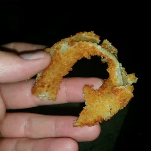 a hand holding a fried donut