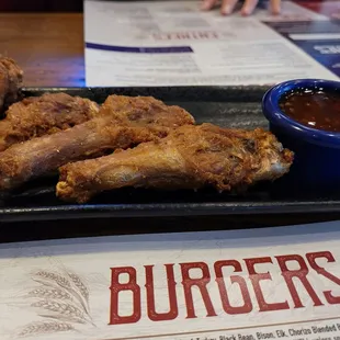 a plate of chicken wings and dipping sauce