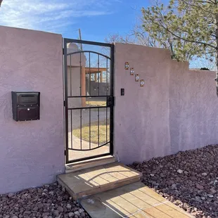 Front courtyard entry with new mailbox, gate and flagstone step / path leading to sidewalk