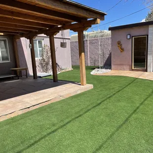 Turf, flagstone under pergola, added sauna, shower, xeriscape, drip, raised and stuccoed walls.