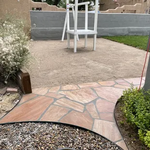 Flagstone landing from flagstone path, sand added to play area