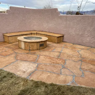Flagstone, fire-it and corner banco inside new courtyard wall