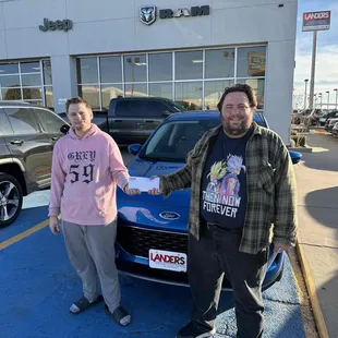 I'm standing in front of my new* vehicle with my daughter's BF just before driving off the lot!!