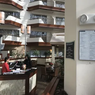 a woman sitting at a table in a restaurant