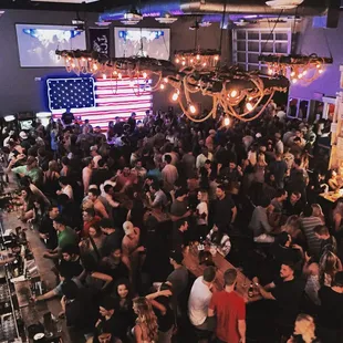 a large crowd of people at a bar