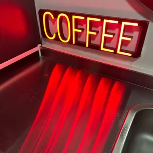 a neon sign on a counter