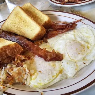 2 eggs, hash browns, bacon  and toast.