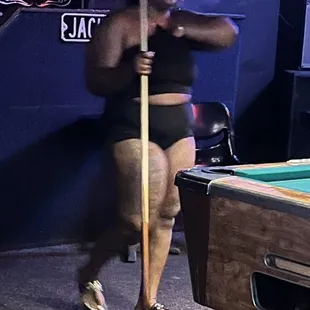 a woman in a bikini playing pool