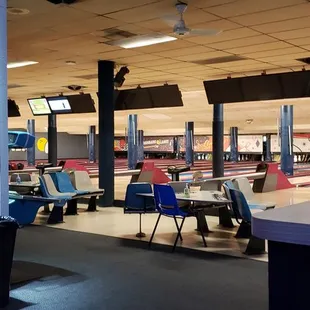 a bowling alley with tables and chairs