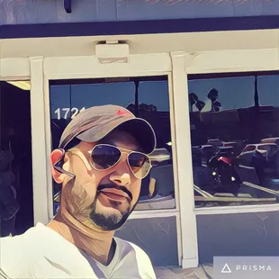 a man wearing sunglasses and a baseball cap