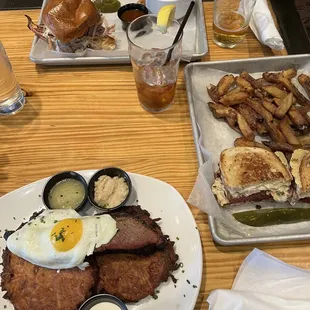 Potato pancakes with brisket (bottom). Pulled pork sandwich with broccoli slaw (top) and Ruben with fries.