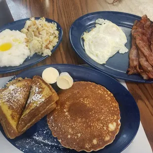 a breakfast of pancakes, eggs, and bacon