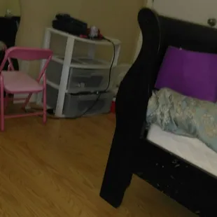 a bedroom with a bed and a desk