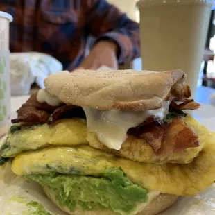 This the House Special Sandwich (as of 18-May-22)! It came with spinach, egg, bacon, LOTS of avocado, swiss cheese on a English muffin.