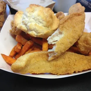 Mixed plate of biscuit, shrimp, fish, and sweet potato fries.