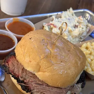 Wagyu brisket sandwich with mac &amp; cheese and potato salad.