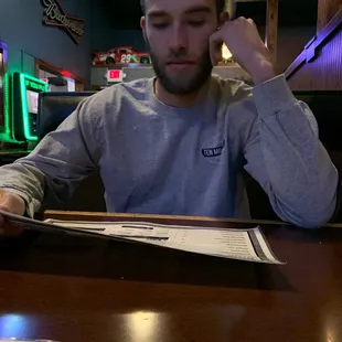 a man reading a menu