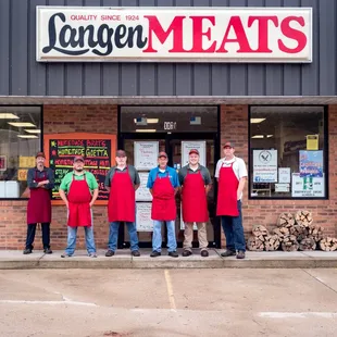 a group of people standing in front of a store