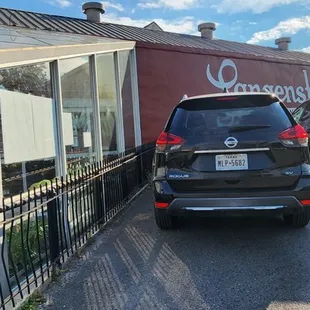 cars parked in front of a restaurant