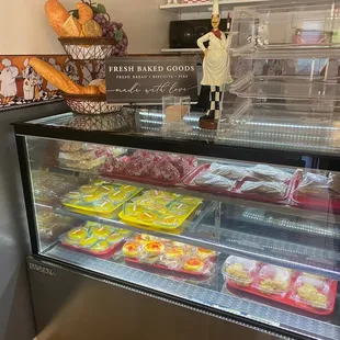 a display case with a variety of baked goods