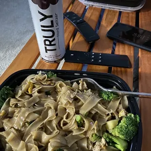 a plate of noodles and broccoli